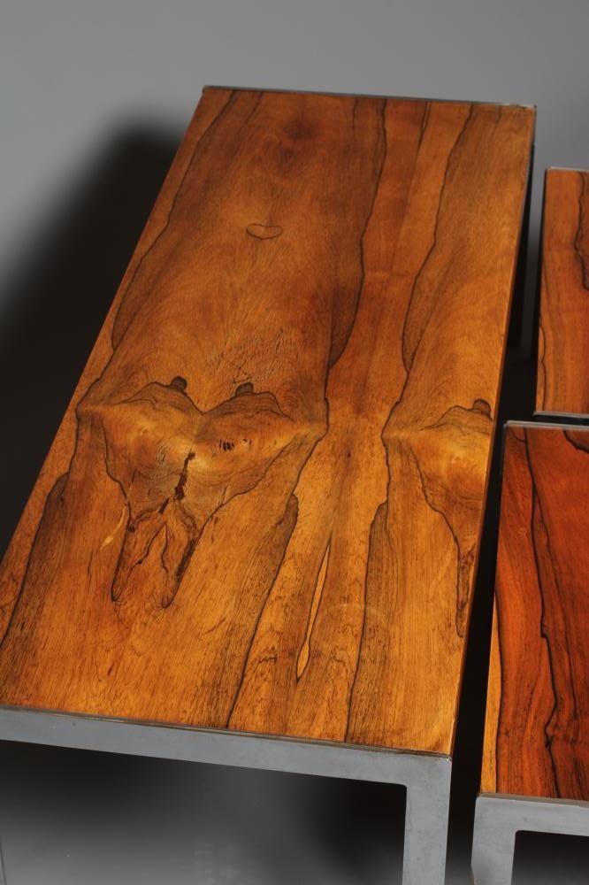 A NEST OF ROSEWOOD COFFEE TABLES Image