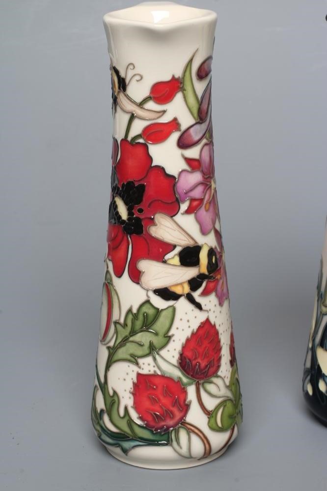 THREE MOORCROFT POTTERY EWERS of tapering cylindrical form Image