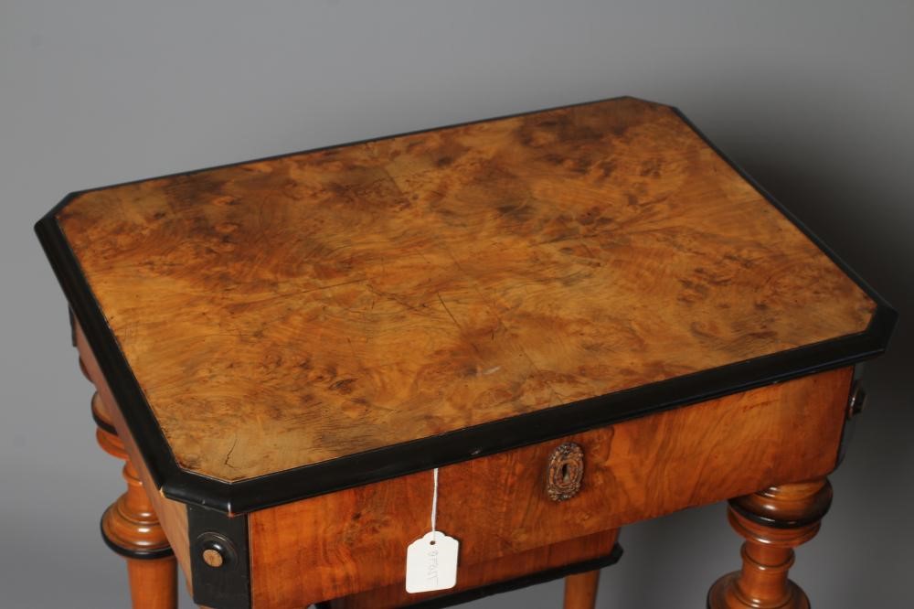 A VICTORIAN WALNUT AND MAPLE SEWING TABLE of canted oblong form with ebony trim Image