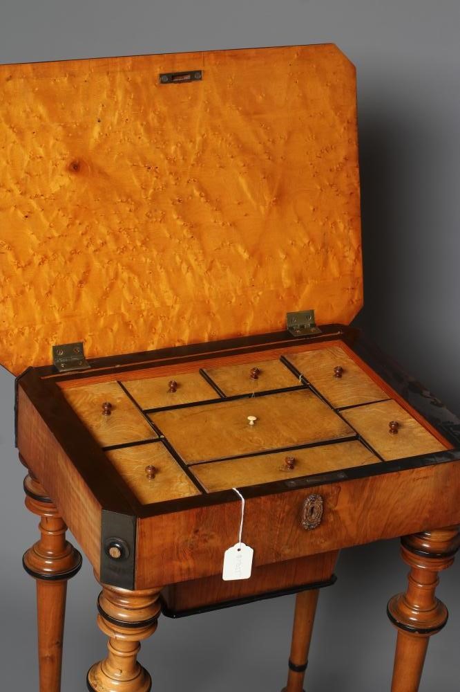 A VICTORIAN WALNUT AND MAPLE SEWING TABLE of canted oblong form with ebony trim Image