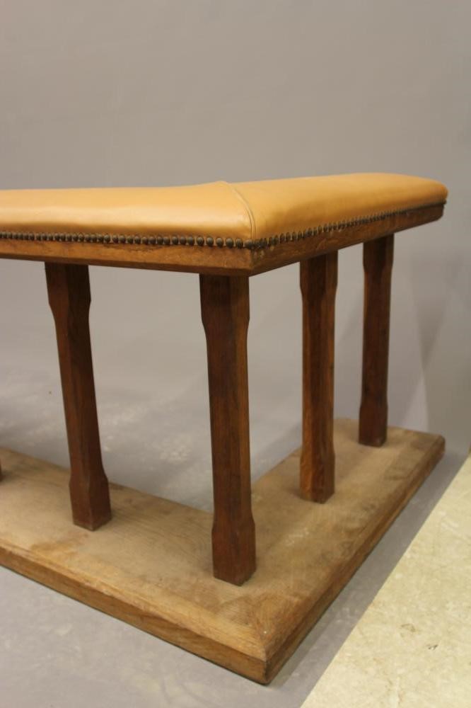 A LARGE OAK CLUB FENDER, 20th century, the padded tan leather seat on square section supports, on Image