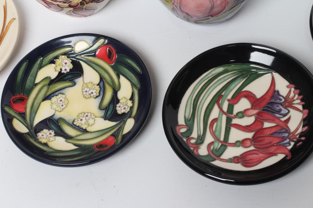 FOUR MOORCROFT POTTERY PIN TRAYS of circular form Image