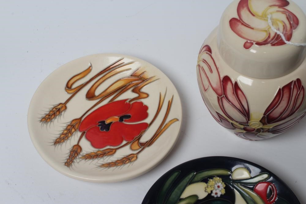 FOUR MOORCROFT POTTERY PIN TRAYS of circular form Image