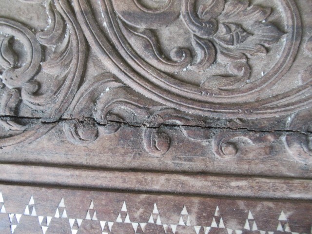 AN INDIAN CARVED WOOD CHEST of oblong form with panels of birds amongst foliate scrolls and with Image
