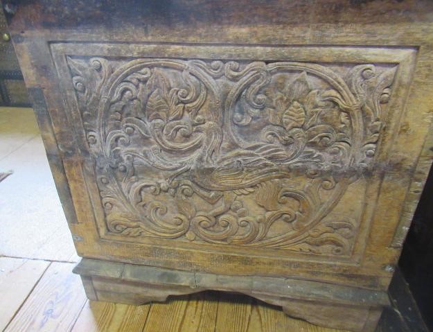 AN INDIAN CARVED WOOD CHEST of oblong form with panels of birds amongst foliate scrolls and with Image