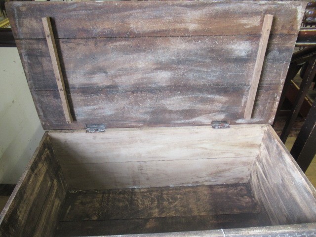 AN INDIAN CARVED WOOD CHEST of oblong form with panels of birds amongst foliate scrolls and with Image