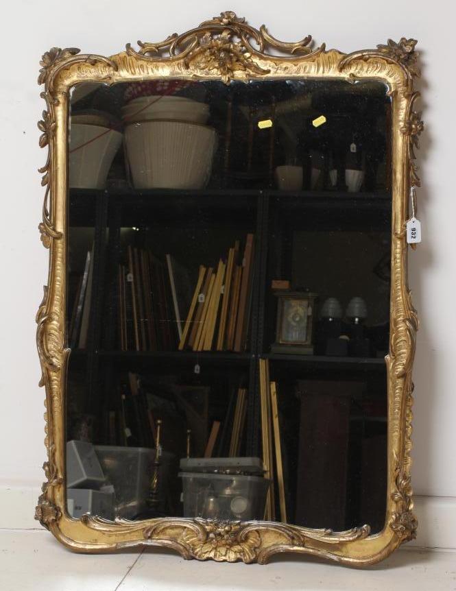 A CARVED AND GILT WOOD PIER GLASS, 19th century, the oblong plate within a rococo style frame with Image