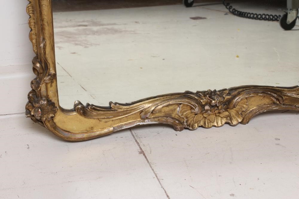 A CARVED AND GILT WOOD PIER GLASS, 19th century, the oblong plate within a rococo style frame with Image