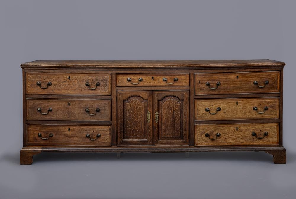 A GEORGIAN OAK AND MAHOGANY BANDED ENCLOSED DRESSER Image