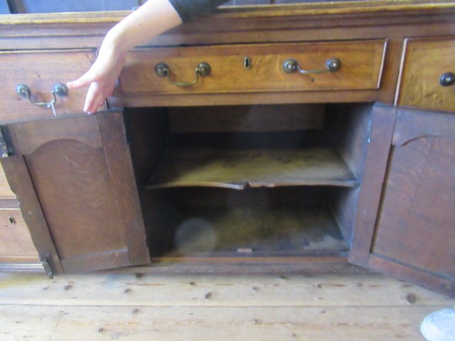 A GEORGIAN OAK AND MAHOGANY BANDED ENCLOSED DRESSER Image