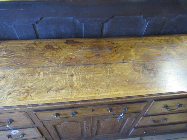 A GEORGIAN OAK AND MAHOGANY BANDED ENCLOSED DRESSER Image