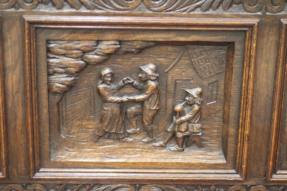 A VICTORIAN CARVED OAK BOX SETTLE Image