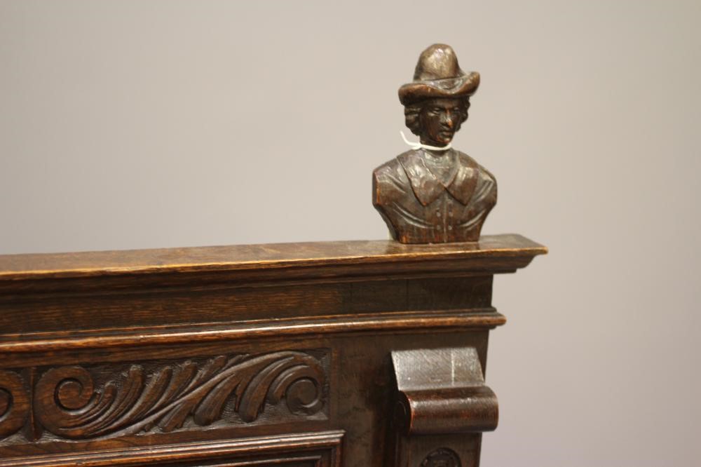 A VICTORIAN CARVED OAK BOX SETTLE Image