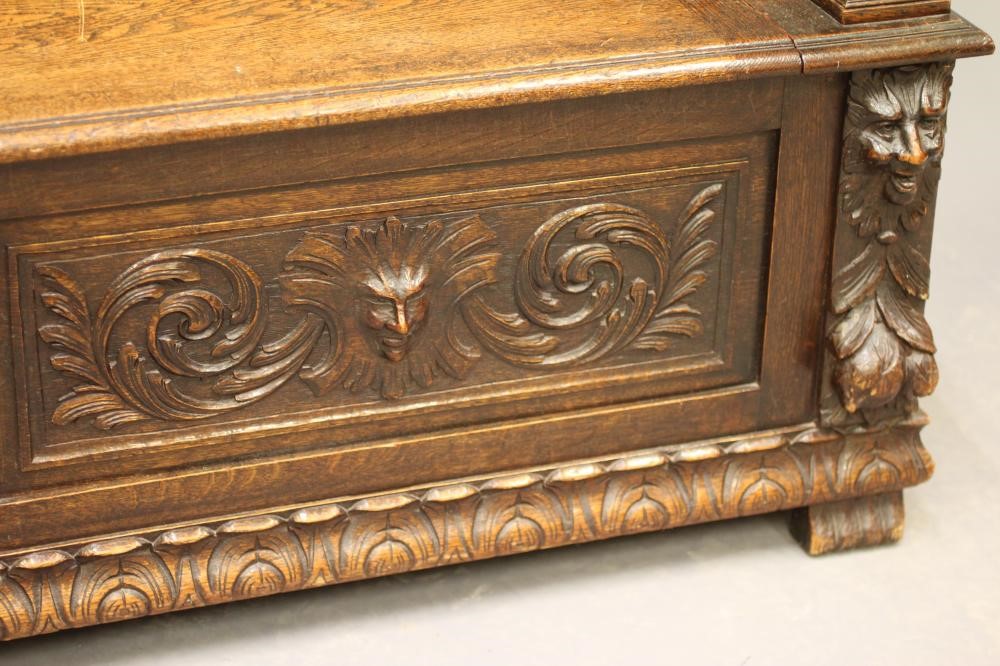 A VICTORIAN CARVED OAK BOX SETTLE Image