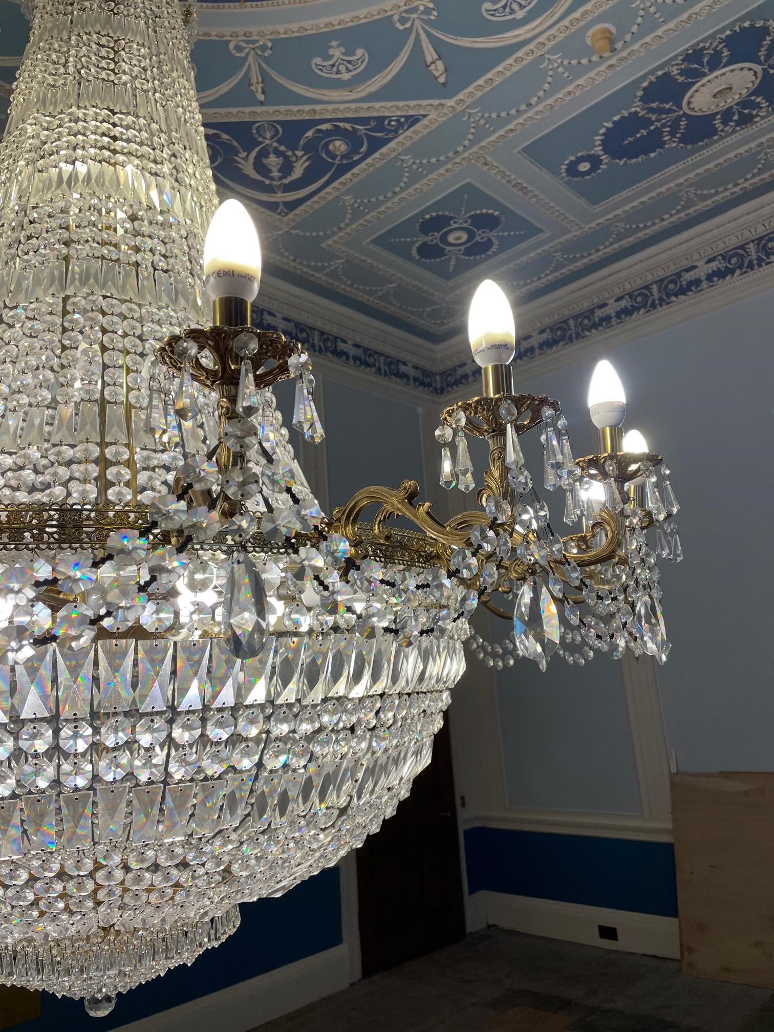 A GILT METAL AND CUT GLASS TWENTY FLAME CHANDELIER Image