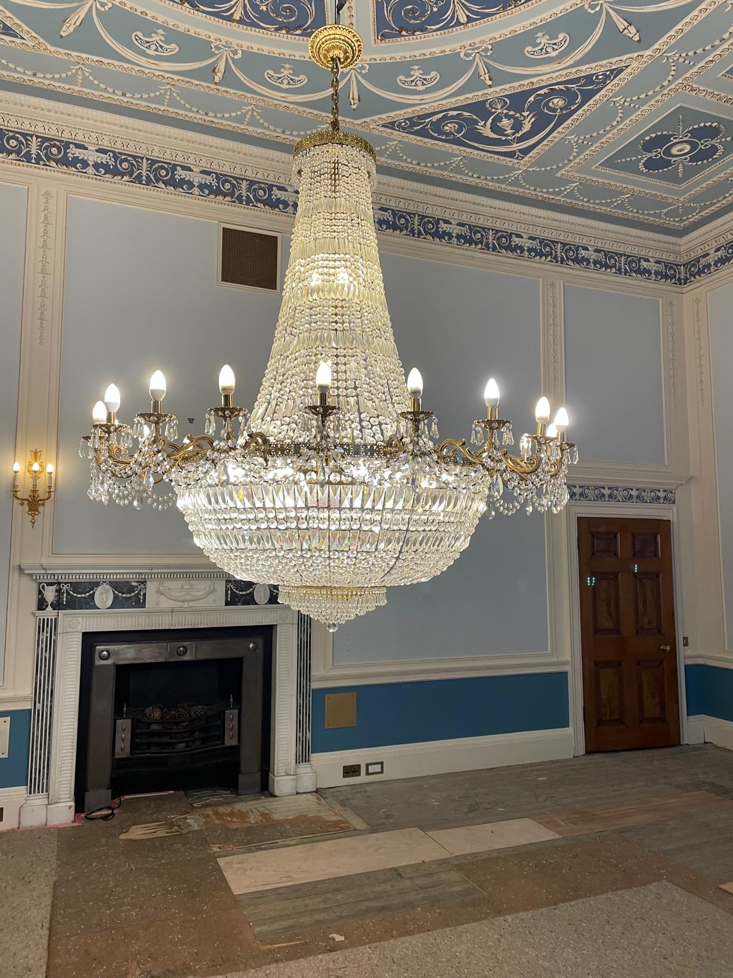 A GILT METAL AND CUT GLASS TWENTY FLAME CHANDELIER Image