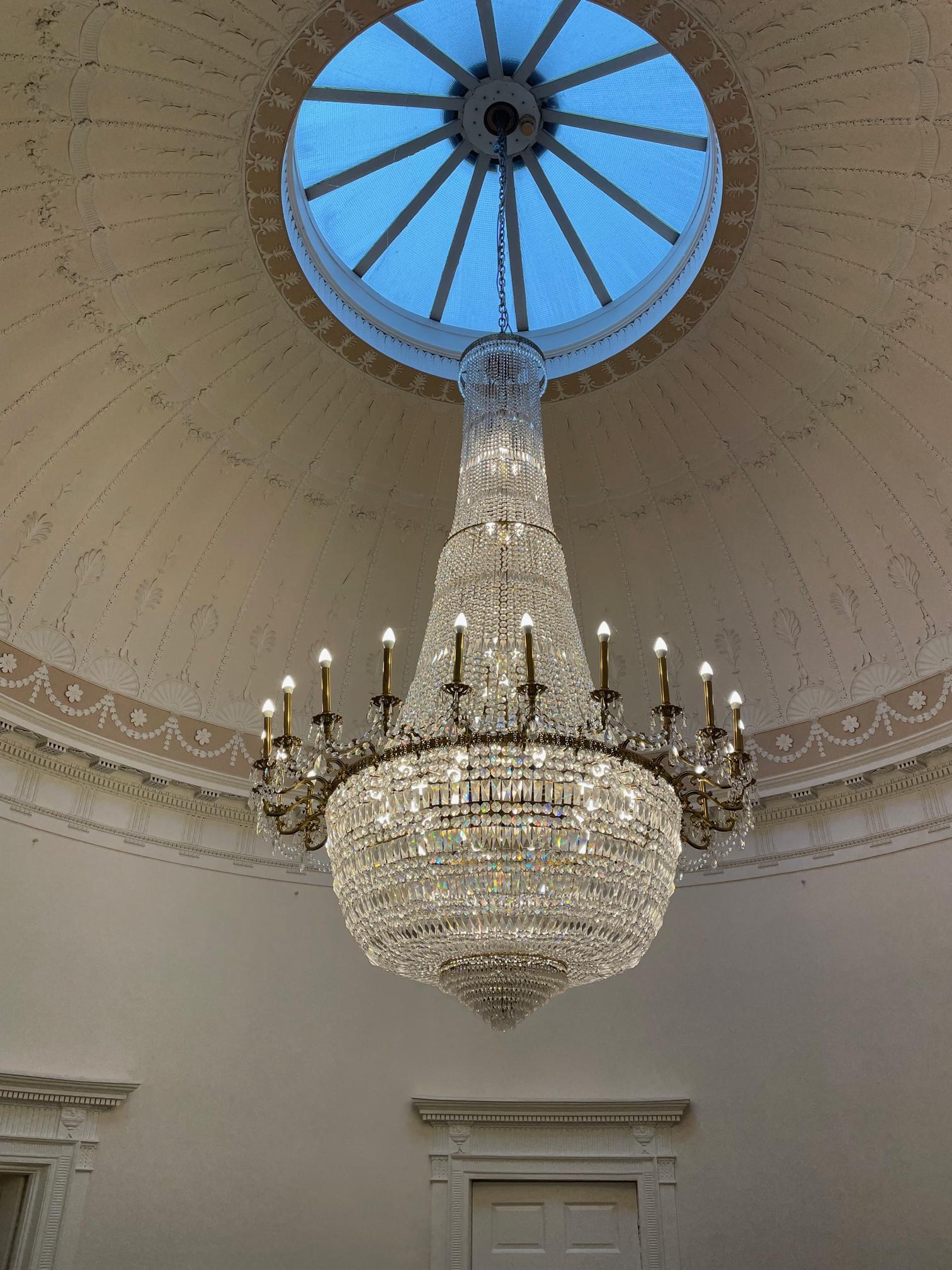 AN IMPRESSIVE GILT METAL AND CUT GLASS TWENTY FOUR FLAME CHANDELIER Image