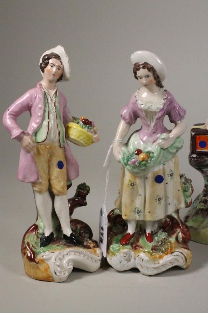 A VICTORIAN STAFFORDSHIRE POTTERY FIGURE of a young boy seated with his arm around a monkey on a Image