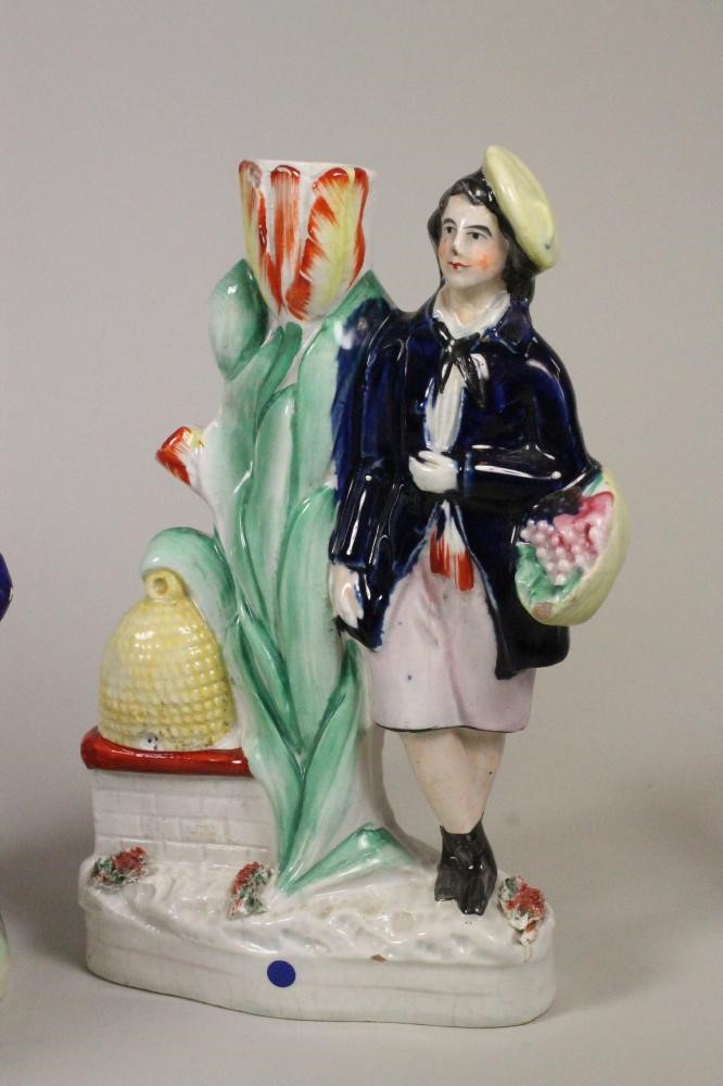 A VICTORIAN STAFFORDSHIRE POTTERY FIGURE of a young boy seated with his arm around a monkey on a Image