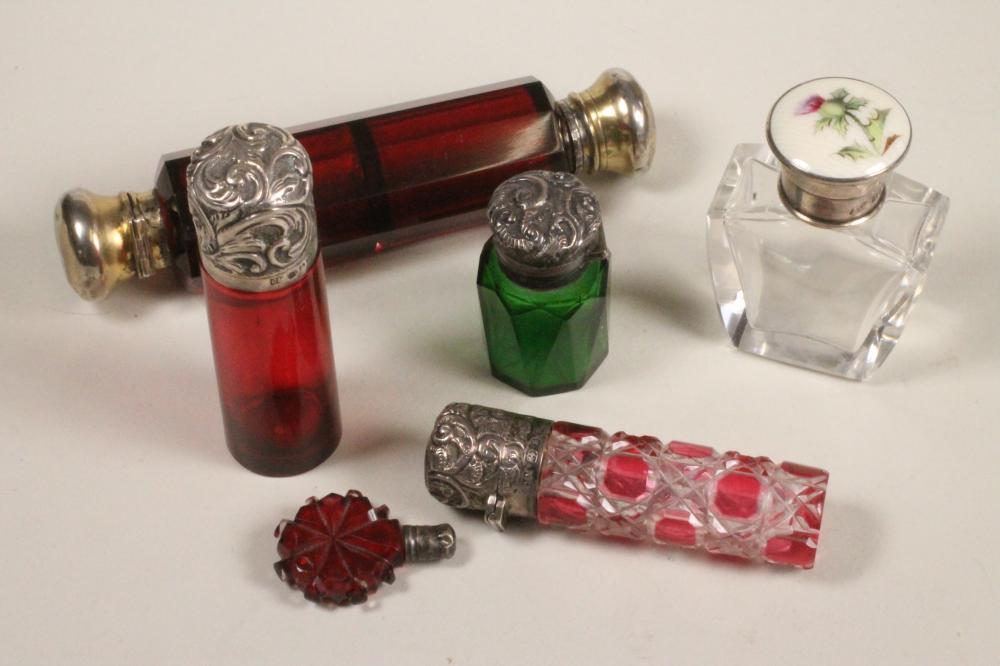 A COLLECTION OF SIX COLOURED GLASS SCENT BOTTLES Image