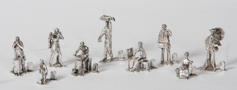 A SET OF NINE NOVELTY SILVER MENU HOLDERS Image
