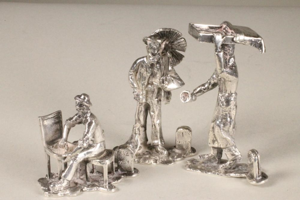 A SET OF NINE NOVELTY SILVER MENU HOLDERS Image