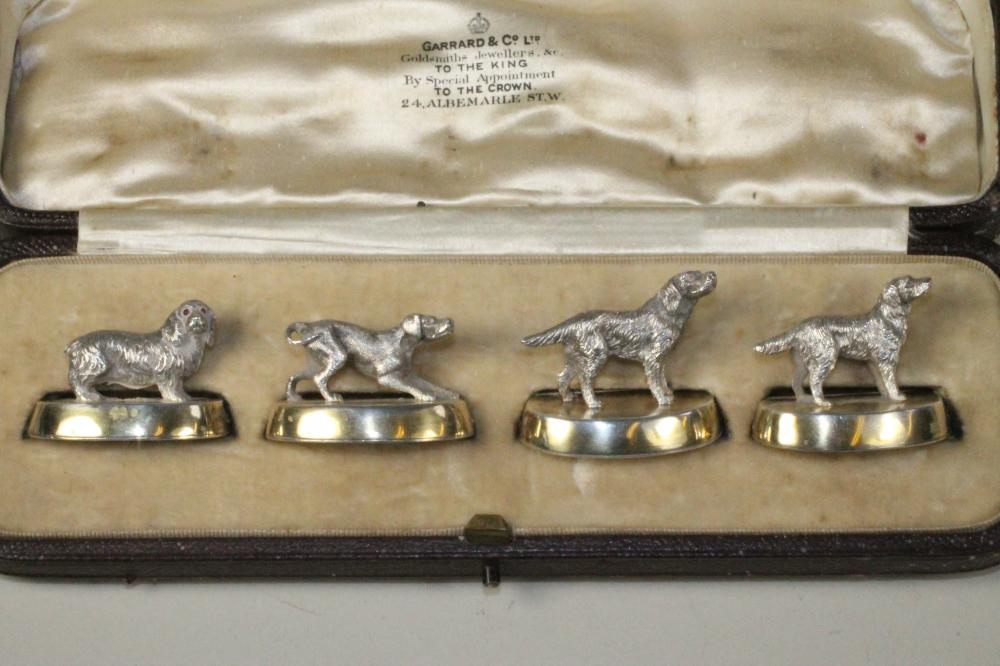 A SET OF FOUR NOVELTY SILVER PLACE CARD HOLDERS Image