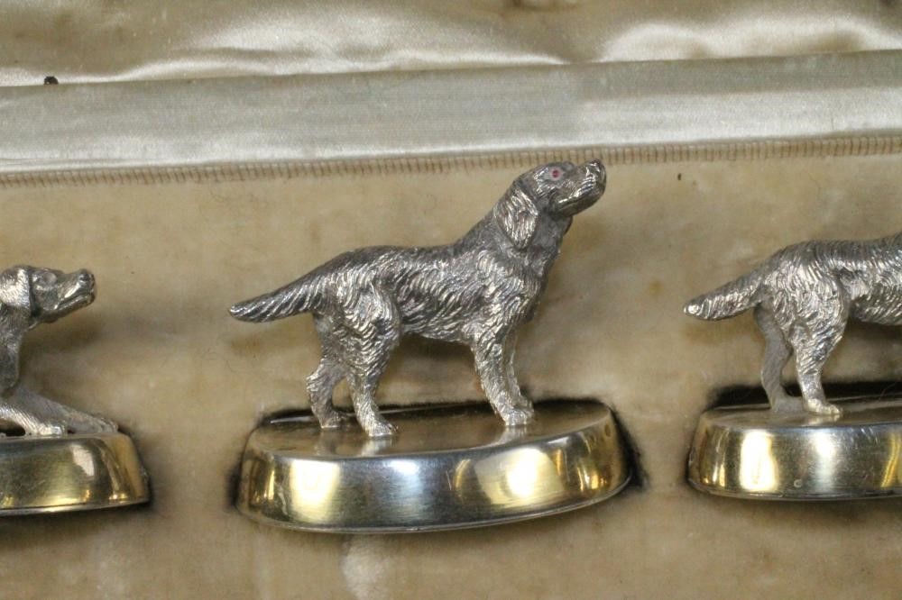 A SET OF FOUR NOVELTY SILVER PLACE CARD HOLDERS Image