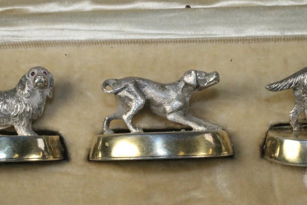 A SET OF FOUR NOVELTY SILVER PLACE CARD HOLDERS Image