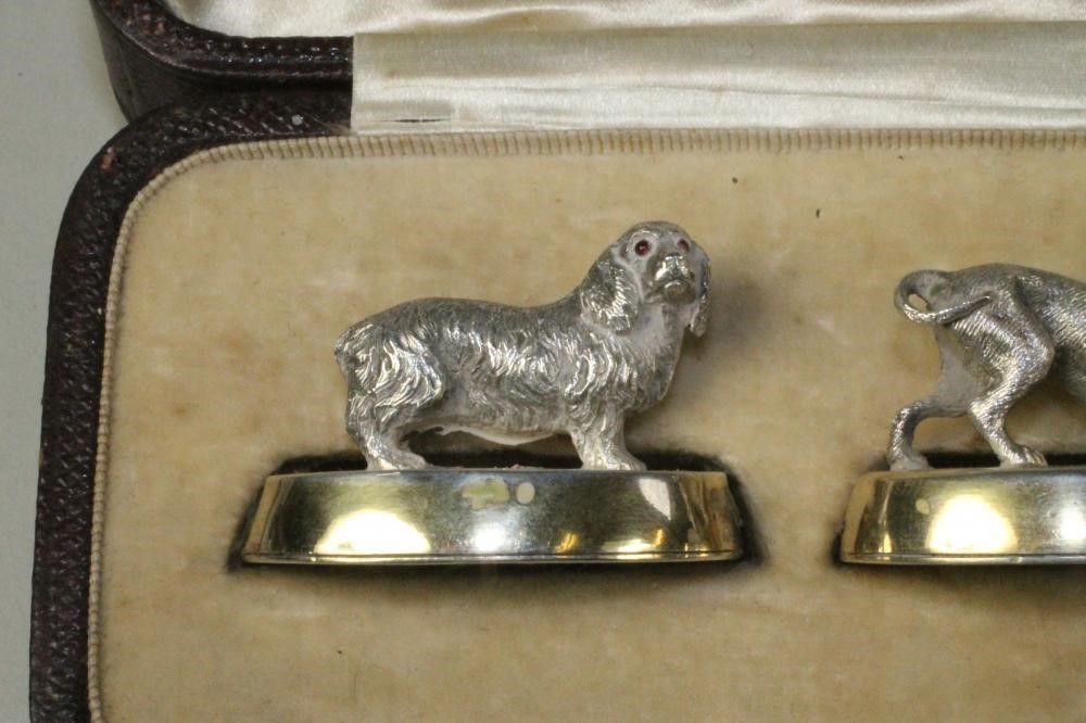 A SET OF FOUR NOVELTY SILVER PLACE CARD HOLDERS Image