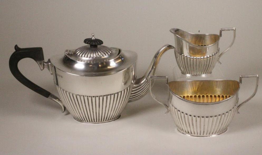 A SILVER THREE PIECE TEA SERVICE Image