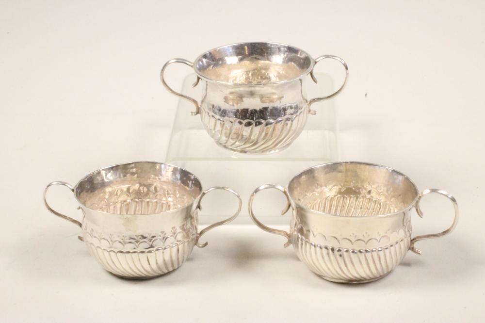 A MATCHED AND COMPOSITE SET OF THREE MINIATURE SILVER PORRINGERS Image