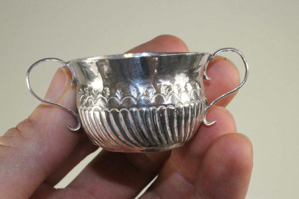 A MATCHED AND COMPOSITE SET OF THREE MINIATURE SILVER PORRINGERS Image