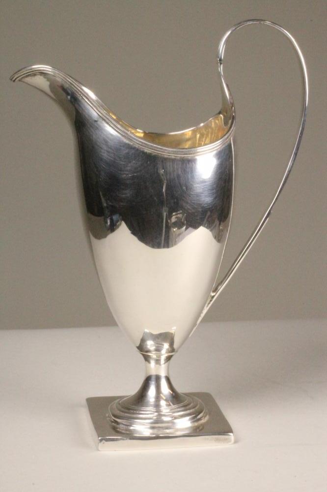 A GEORGE III SILVER CREAM JUG Image