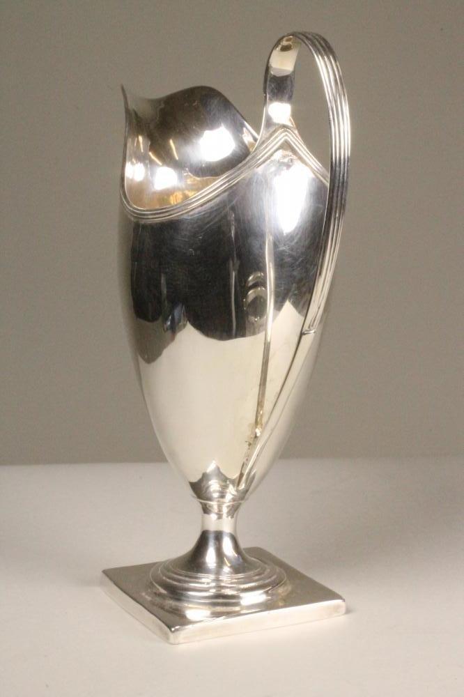 A GEORGE III SILVER CREAM JUG Image