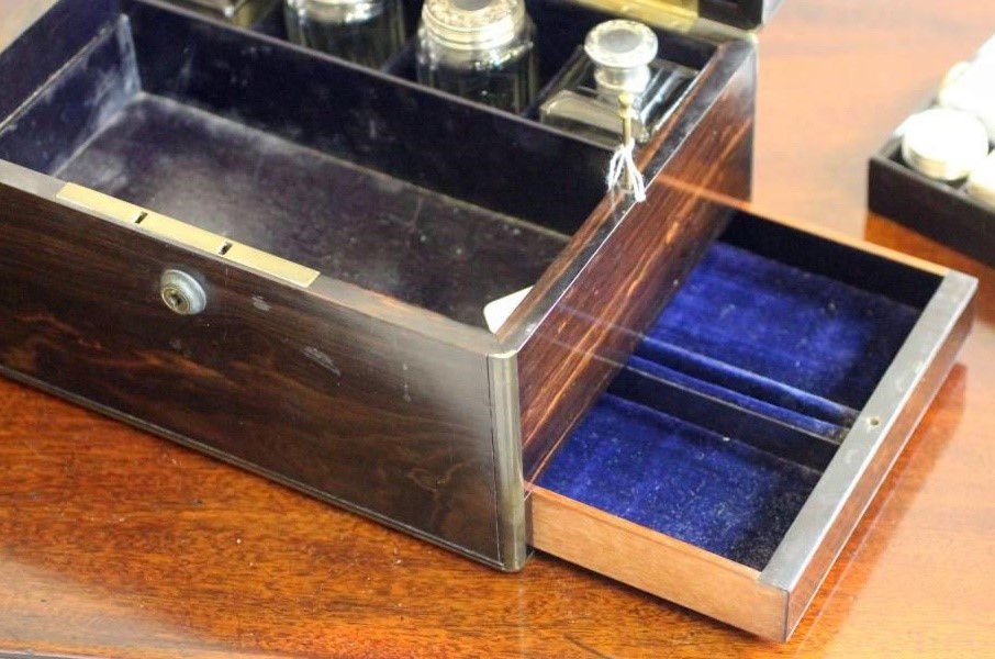 A VICTORIAN COROMANDEL TRAVELLING TOILET CASE of plain oblong form banded with brass and with inlaid Image