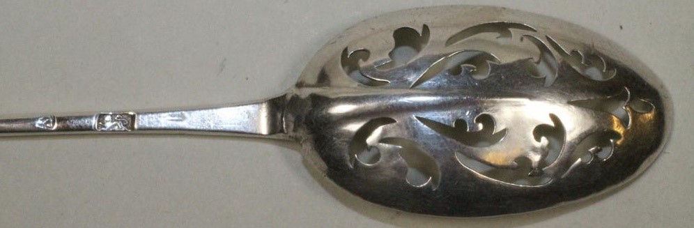 A LATE GEORGE II SILVER MOTE SPOON Image
