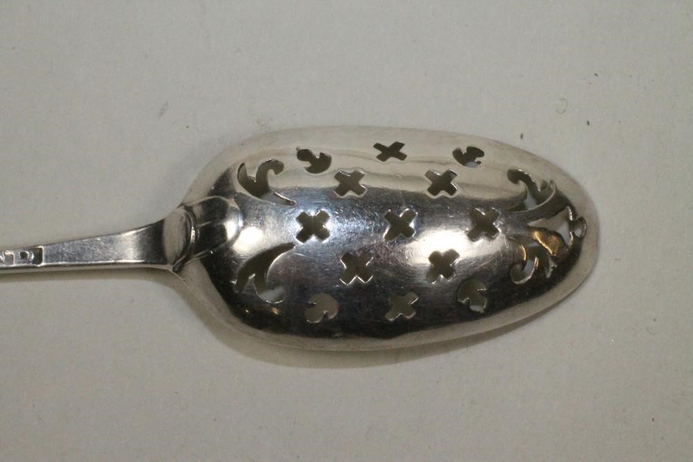 A GEORGE III SILVER MOTE SPOON Image