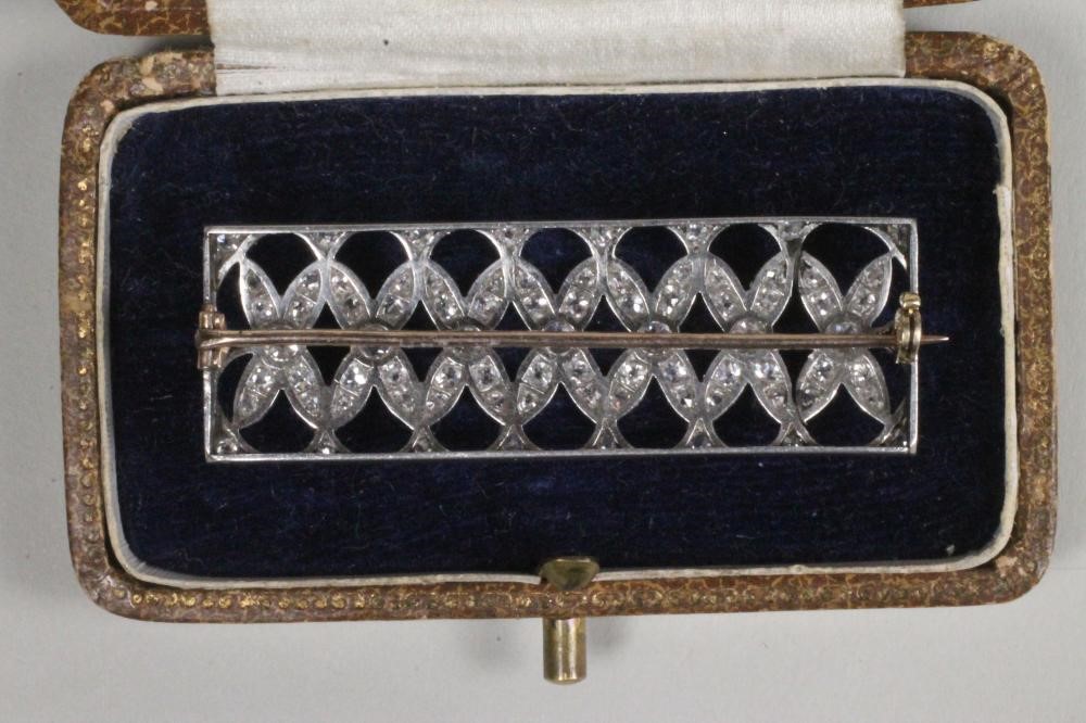 AN ART DECO DIAMOND PANEL BROOCH of plain oblong form with an open grid pave set with numerous Image