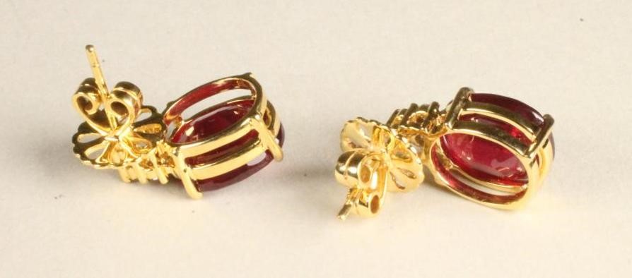A PAIR OF RUBY EAR STUDS to match the previous lot Image