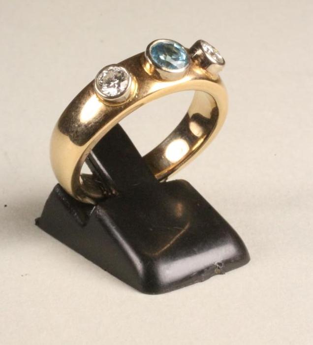 AN AQUAMARINE AND DIAMOND THREE STONE RING Image