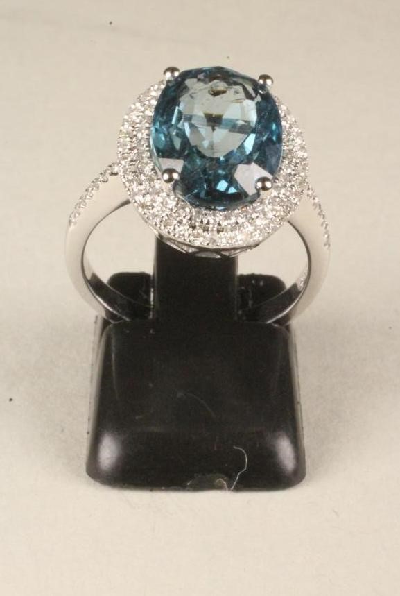 A TOPAZ AND DIAMOND CLUSTER RING Image