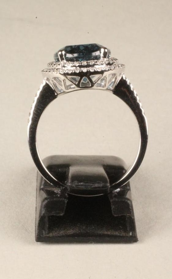 A TOPAZ AND DIAMOND CLUSTER RING Image
