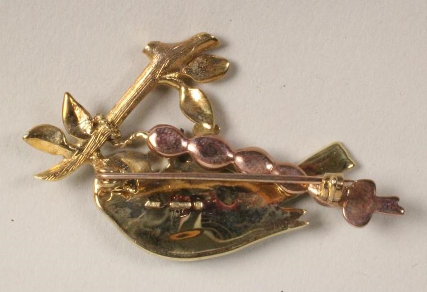 A 9CT GOLD AND COLOURED ENAMEL BROOCH modelled as a bluetit perched upon a leafy branch Image