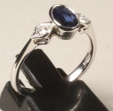 A SAPPHIRE AND DIAMOND THREE STONE RING Image