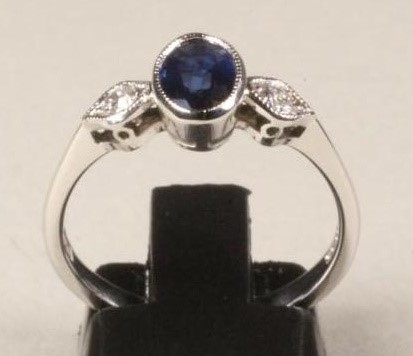 A SAPPHIRE AND DIAMOND THREE STONE RING Image