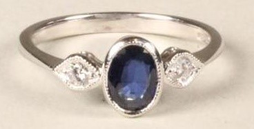 A SAPPHIRE AND DIAMOND THREE STONE RING Image