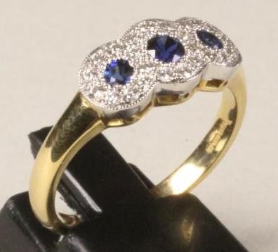 A SAPPHIRE AND DIAMOND TRIPLE CLUSTER RING Image