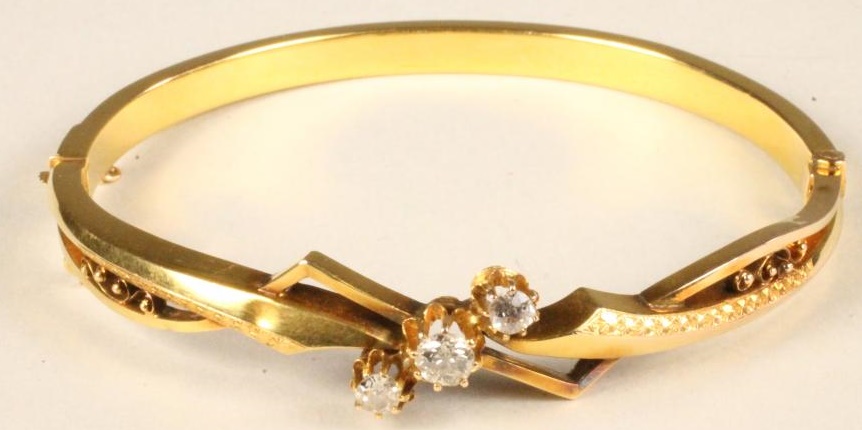 A LATE VICTORIAN GOLD STIFF HINGED BANGLE Image