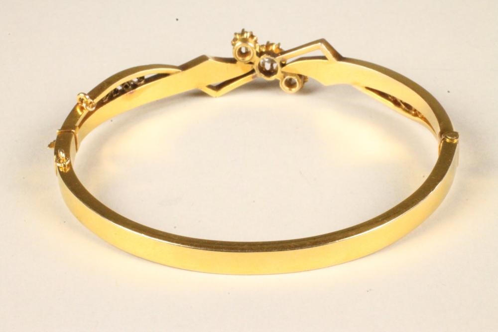 A LATE VICTORIAN GOLD STIFF HINGED BANGLE Image